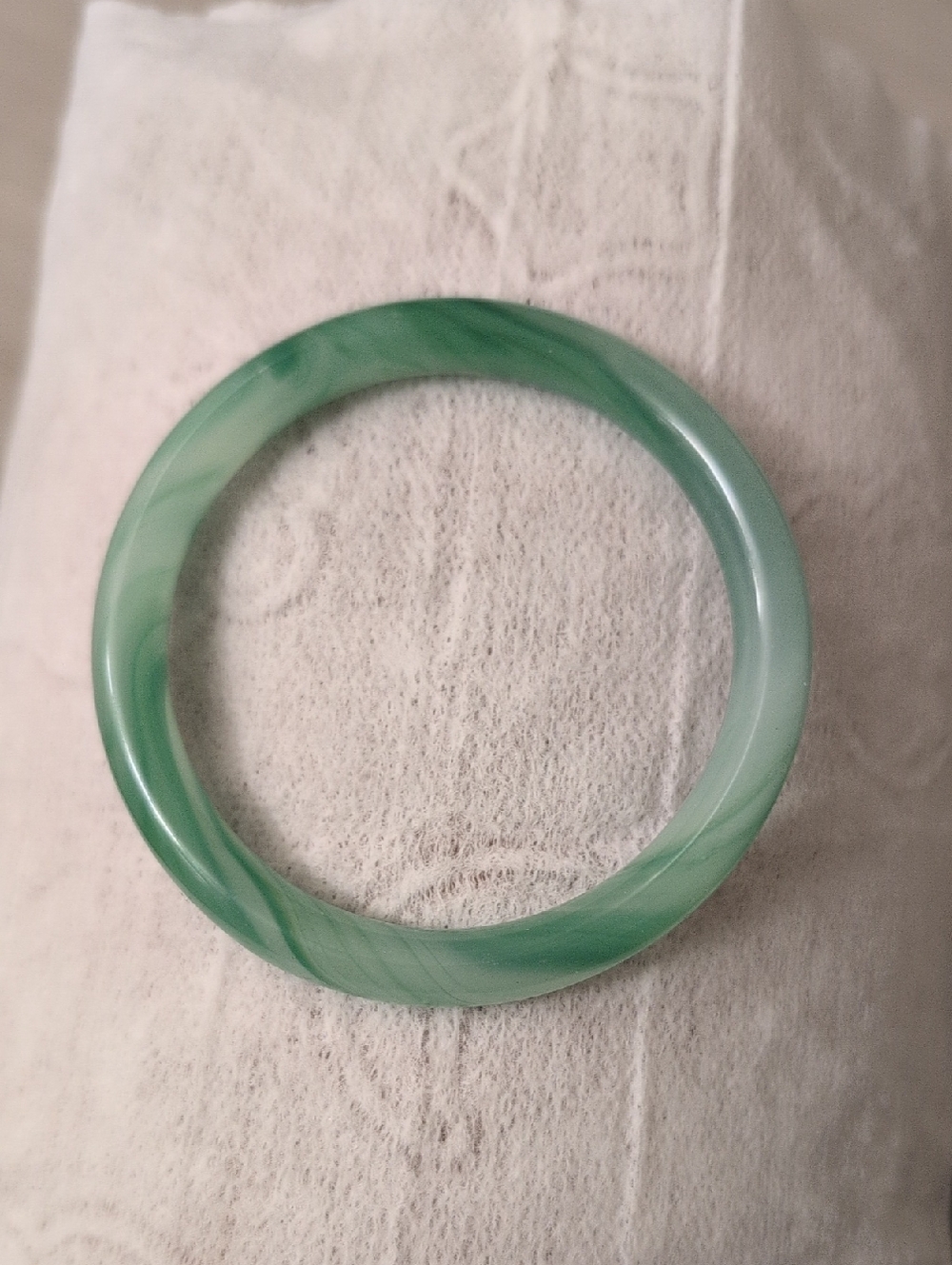 This product is a traditional cylindrical green jadeite bangle bracelet,